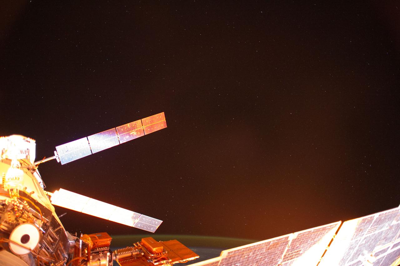 ISS041-E-013693 (13 Sept. 2014) --- Photographed with a mounted automated camera, this is one of a number of images featuring the European Space Agency?s Automated Transfer Vehicle (ATV-5 or Georges Lemaitre) docked with the International Space Station.  Except for color changes, the images are almost identical.  The variation in color from frame to frame is due to the camera?s response to the motion of the orbital outpost, relative to the illumination from the sun.