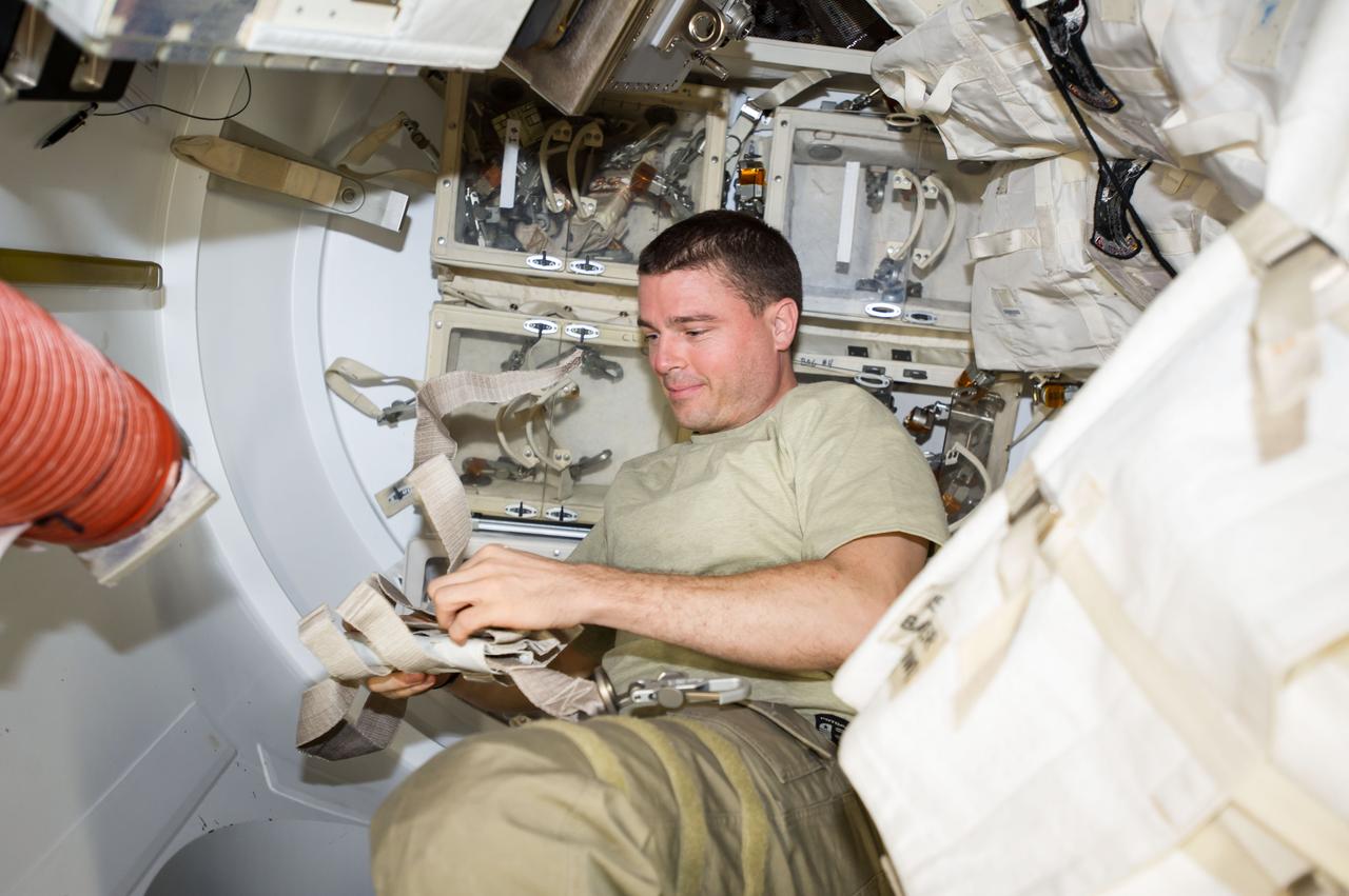 ISS041-E-017060 (19 Sept. 2014) --- NASA astronaut Reid Wiseman, Expedition 41 flight engineer, works with tools and equipment in the Quest airlock of the International Space Station in preparation for two spacewalks scheduled in October 2014.