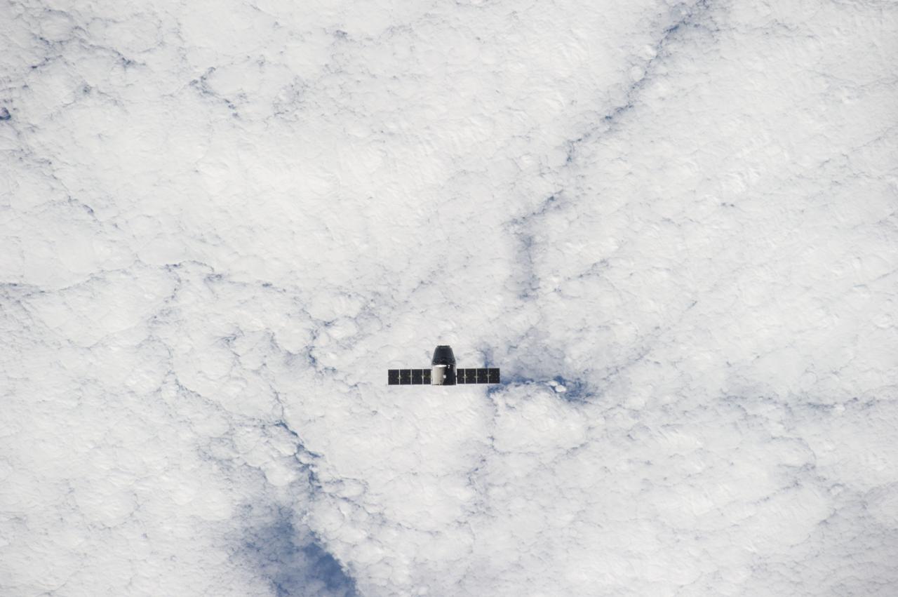 ISS041-E-020655 (23 Sept. 2014) --- The SpaceX Dragon commercial cargo craft approaches the International Space Station on Sept. 23, 2014 for grapple and berthing. European Space Agency astronaut Alexander Gerst and NASA astronaut Reid Wiseman, both Expedition 41 flight engineers, were at the controls of the robotics workstation in the Cupola when the Canadarm2 grappled Dragon at 6:52 a.m. (EDT). Dragon will spend the next four weeks attached to the Harmony node as the Expedition 41 crew unloads 4,885 pounds of (2,216 kg) crew supplies, hardware, experiments, and computer gear and spacewalk equipment.