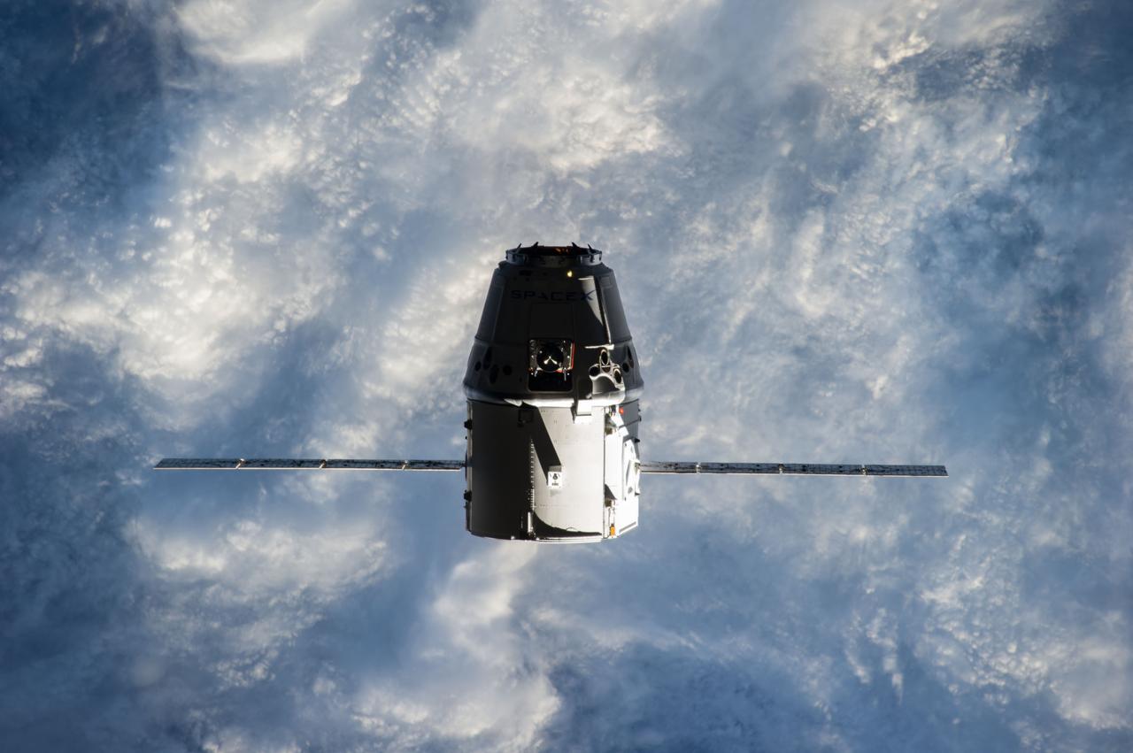 ISS041-E-020800 (23 Sept. 2014) --- The SpaceX Dragon commercial cargo craft approaches the International Space Station on Sept. 23, 2014 for grapple and berthing. European Space Agency astronaut Alexander Gerst and NASA astronaut Reid Wiseman, both Expedition 41 flight engineers, were at the controls of the robotics workstation in the Cupola when the Canadarm2 grappled Dragon at 6:52 a.m. (EDT). Dragon will spend the next four weeks attached to the Harmony node as the Expedition 41 crew unloads 4,885 pounds of (2,216 kg) crew supplies, hardware, experiments, and computer gear and spacewalk equipment.
