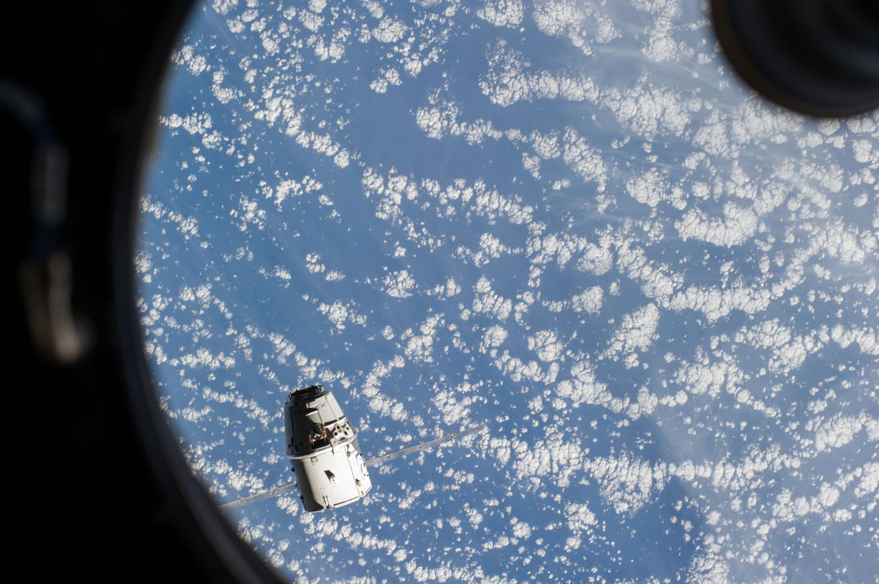 ISS041-E-020806 (23 Sept. 2014) --- Photographed by an Expedition 41 crew member from the windows of the Cupola, the SpaceX Dragon commercial cargo craft approaches the International Space Station on Sept. 23, 2014.