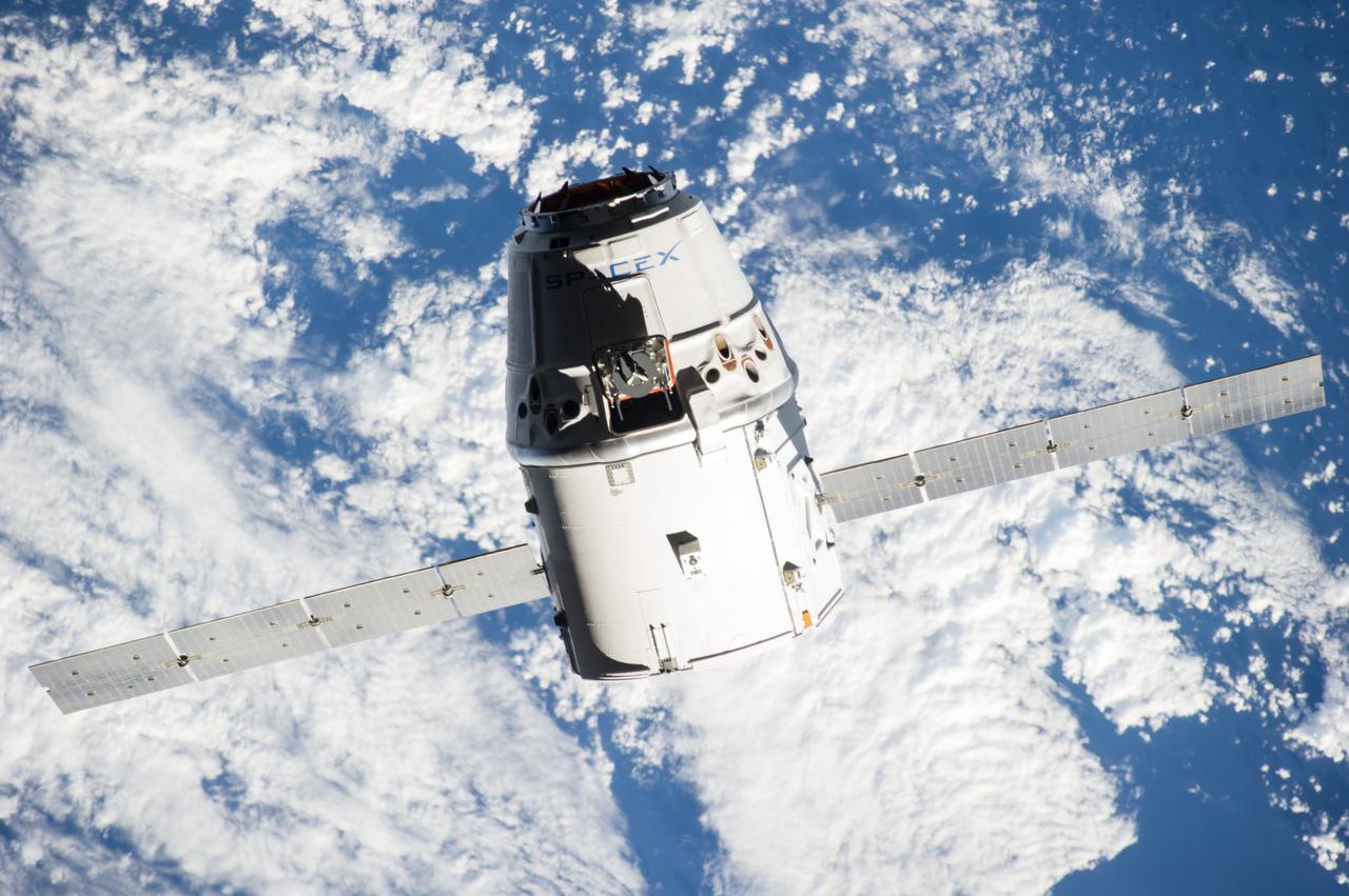 ISS041-E-020821 (23 Sept. 2014) --- The SpaceX Dragon commercial cargo craft approaches the International Space Station on Sept. 23, 2014 for grapple and berthing. European Space Agency astronaut Alexander Gerst and NASA astronaut Reid Wiseman, both Expedition 41 flight engineers, were at the controls of the robotics workstation in the Cupola when the Canadarm2 grappled Dragon at 6:52 a.m. (EDT). Dragon will spend the next four weeks attached to the Harmony node as the Expedition 41 crew unloads 4,885 pounds of (2,216 kg) crew supplies, hardware, experiments, and computer gear and spacewalk equipment.