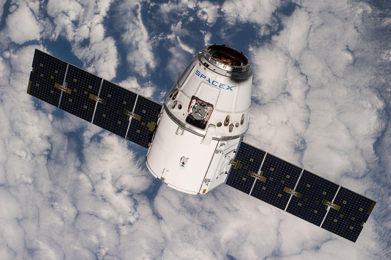 ISS041-E-020918 (23 Sept. 2014) --- The SpaceX Dragon commercial cargo craft approaches the International Space Station on Sept. 23, 2014 for grapple and berthing. European Space Agency astronaut Alexander Gerst and NASA astronaut Reid Wiseman, both Expedition 41 flight engineers, were at the controls of the robotics workstation in the Cupola when the Canadarm2 grappled Dragon at 6:52 a.m. (EDT). Dragon will spend the next four weeks attached to the Harmony node as the Expedition 41 crew unloads 4,885 pounds of (2,216 kg) crew supplies, hardware, experiments, and computer gear and spacewalk equipment.