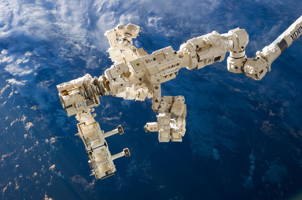 ISS041-E-049091 (30 Sept. 2014) --- The International Space Station?s Canadarm2 and Dextre, also known as the Special Purpose Dextrous Manipulator (SPDM), carry the Rapidscat instrument assembly after removing it from the trunk of the SpaceX Dragon cargo ship, which is currently docked to the nadir port of the Harmony node. The Rapidscat was then maneuvered for attachment to the nadir adapter that is affixed to the station?s Columbus laboratory.