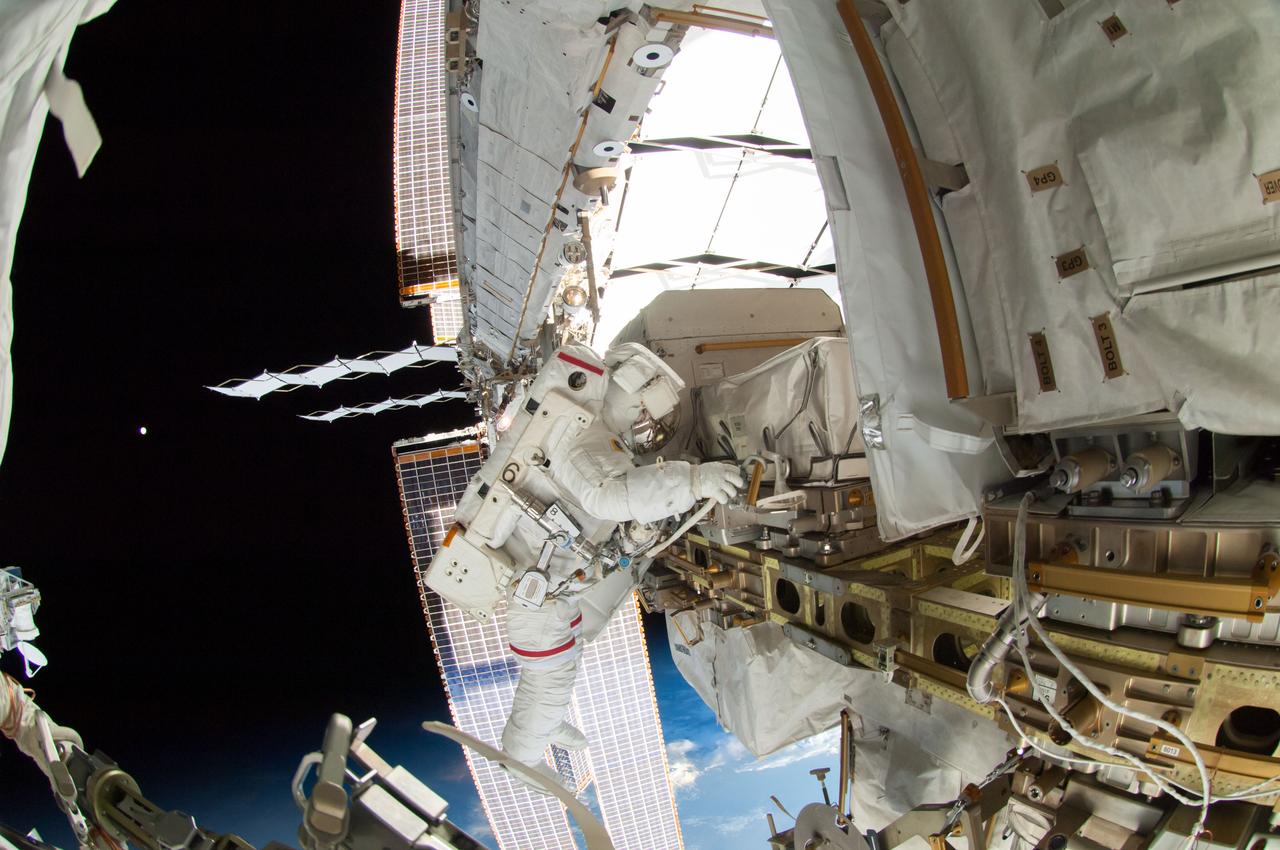ISS041-E-067002 (7 Oct. 2014) --- NASA astronaut Reid Wiseman, Expedition 41 flight engineer, participates in a session of extravehicular activity (EVA) as work continues on the International Space Station. During the six-hour, 13-minute spacewalk, Wiseman and European Space Agency astronaut Alexander Gerst (out of frame), flight engineer, worked outside the space station's Quest airlock relocating a failed cooling pump to external stowage and installing gear that provides back up power to external robotics equipment.