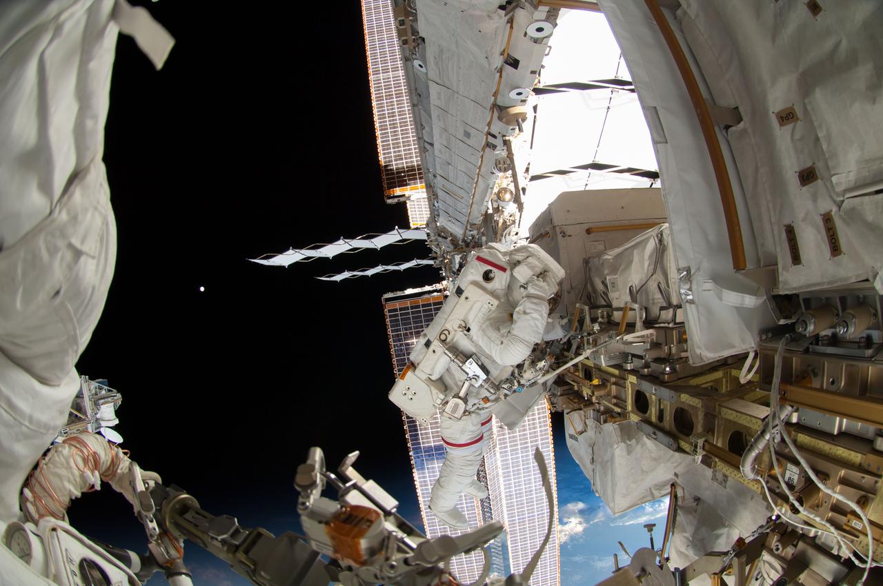 ISS041-E-067002 (7 Oct. 2014) --- NASA astronaut Reid Wiseman, Expedition 41 flight engineer, participates in a session of extravehicular activity (EVA) as work continues on the International Space Station. During the six-hour, 13-minute spacewalk, Wiseman and European Space Agency astronaut Alexander Gerst (out of frame), flight engineer, worked outside the space station's Quest airlock relocating a failed cooling pump to external stowage and installing gear that provides back up power to external robotics equipment.