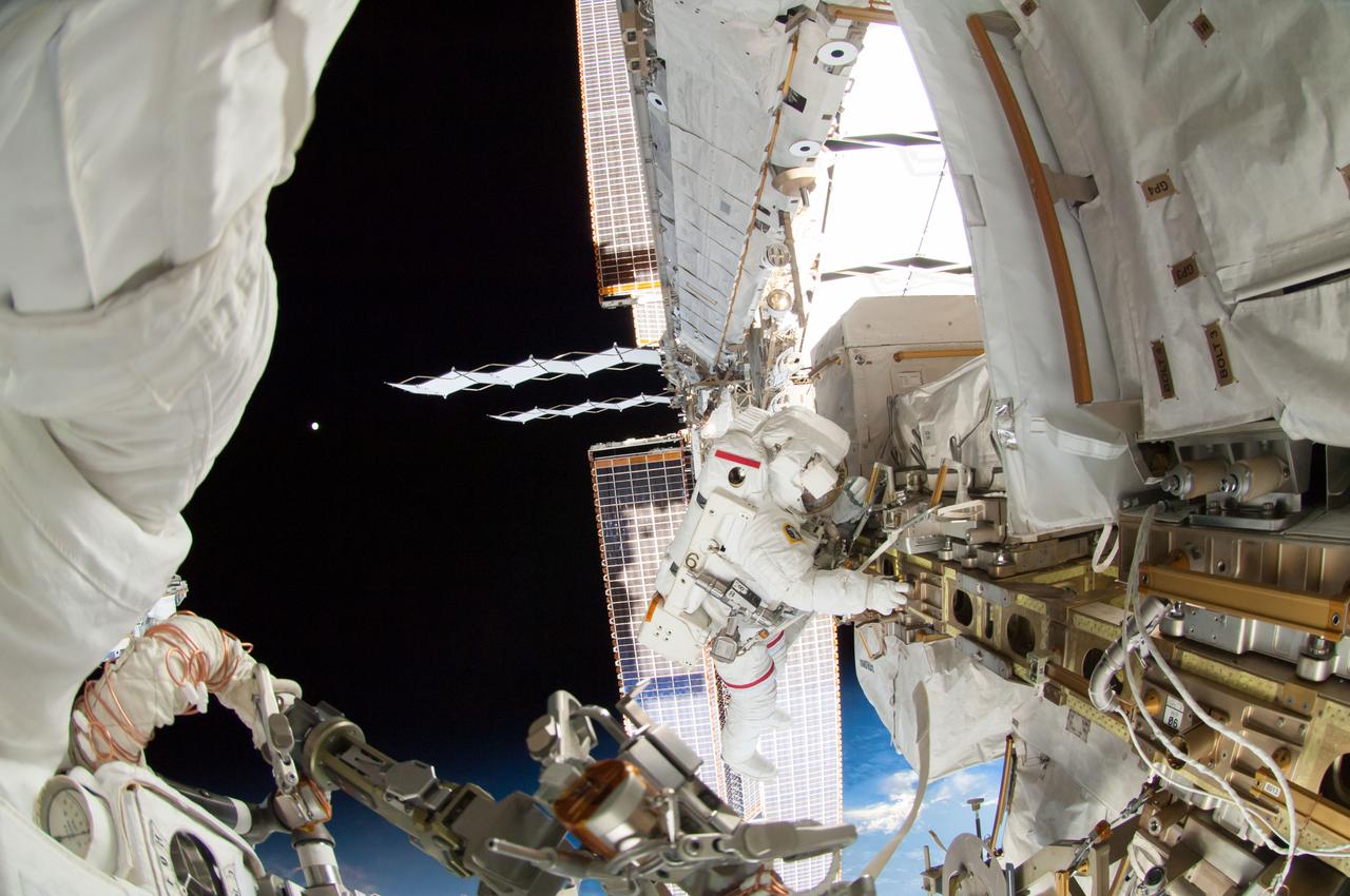 ISS041-E-067002 (7 Oct. 2014) --- NASA astronaut Reid Wiseman, Expedition 41 flight engineer, participates in a session of extravehicular activity (EVA) as work continues on the International Space Station. During the six-hour, 13-minute spacewalk, Wiseman and European Space Agency astronaut Alexander Gerst (out of frame), flight engineer, worked outside the space station's Quest airlock relocating a failed cooling pump to external stowage and installing gear that provides back up power to external robotics equipment.