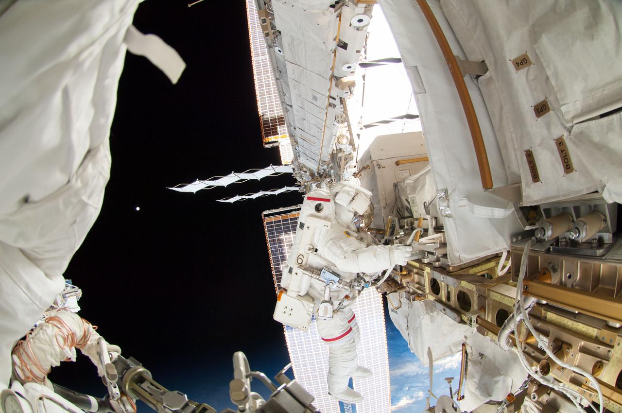 ISS041-E-067002 (7 Oct. 2014) --- NASA astronaut Reid Wiseman, Expedition 41 flight engineer, participates in a session of extravehicular activity (EVA) as work continues on the International Space Station. During the six-hour, 13-minute spacewalk, Wiseman and European Space Agency astronaut Alexander Gerst (out of frame), flight engineer, worked outside the space station's Quest airlock relocating a failed cooling pump to external stowage and installing gear that provides back up power to external robotics equipment.