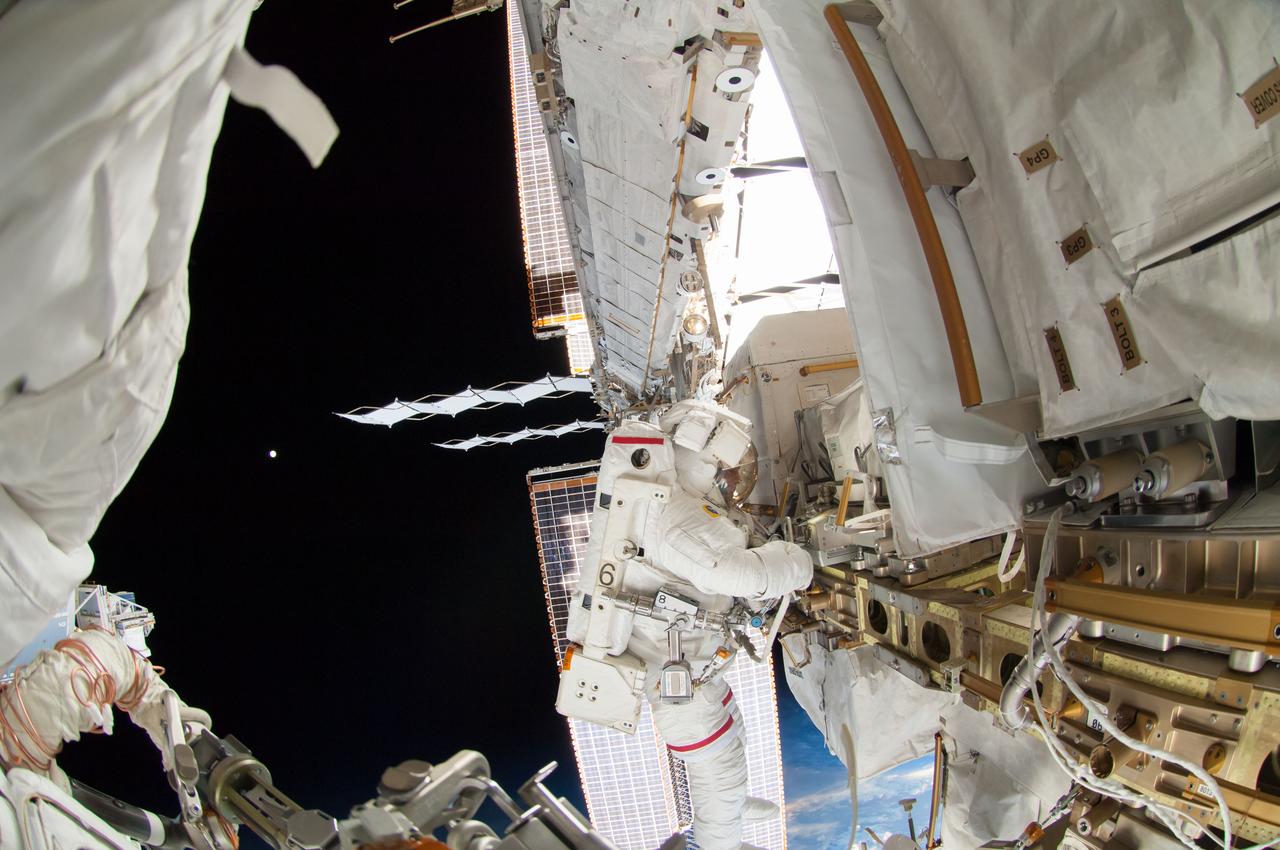 ISS041-E-067002 (7 Oct. 2014) --- NASA astronaut Reid Wiseman, Expedition 41 flight engineer, participates in a session of extravehicular activity (EVA) as work continues on the International Space Station. During the six-hour, 13-minute spacewalk, Wiseman and European Space Agency astronaut Alexander Gerst (out of frame), flight engineer, worked outside the space station's Quest airlock relocating a failed cooling pump to external stowage and installing gear that provides back up power to external robotics equipment.