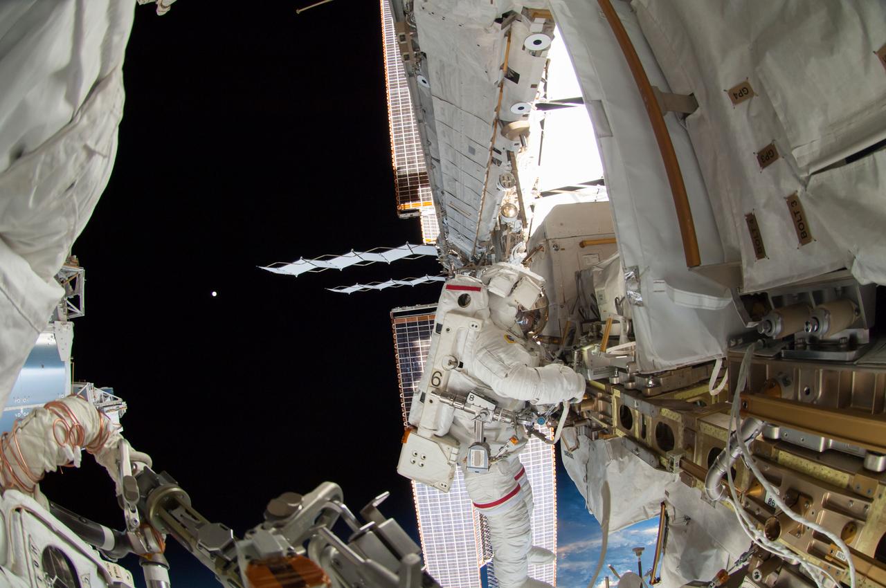 ISS041-E-067002 (7 Oct. 2014) --- NASA astronaut Reid Wiseman, Expedition 41 flight engineer, participates in a session of extravehicular activity (EVA) as work continues on the International Space Station. During the six-hour, 13-minute spacewalk, Wiseman and European Space Agency astronaut Alexander Gerst (out of frame), flight engineer, worked outside the space station's Quest airlock relocating a failed cooling pump to external stowage and installing gear that provides back up power to external robotics equipment.