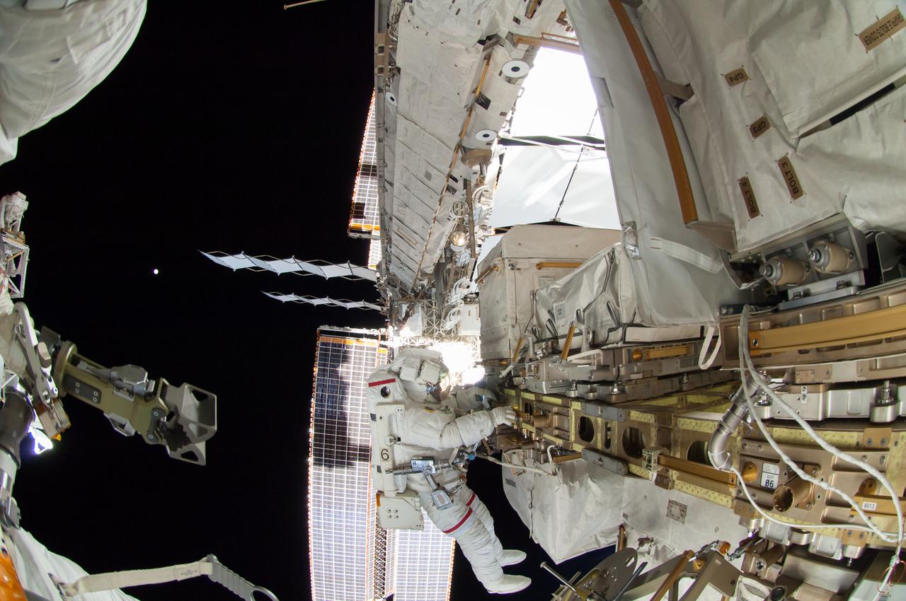 ISS041-E-067002 (7 Oct. 2014) --- NASA astronaut Reid Wiseman, Expedition 41 flight engineer, participates in a session of extravehicular activity (EVA) as work continues on the International Space Station. During the six-hour, 13-minute spacewalk, Wiseman and European Space Agency astronaut Alexander Gerst (out of frame), flight engineer, worked outside the space station's Quest airlock relocating a failed cooling pump to external stowage and installing gear that provides back up power to external robotics equipment.