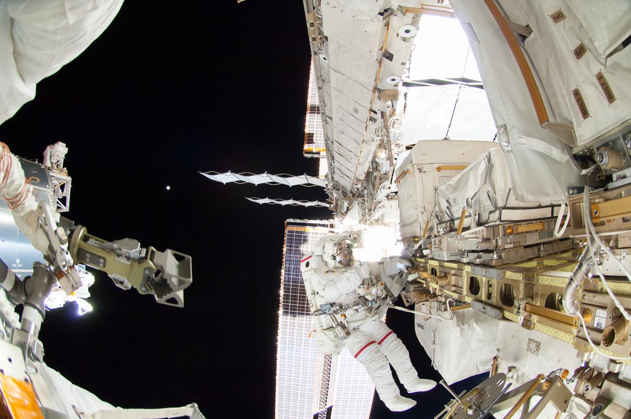 ISS041-E-067002 (7 Oct. 2014) --- NASA astronaut Reid Wiseman, Expedition 41 flight engineer, participates in a session of extravehicular activity (EVA) as work continues on the International Space Station. During the six-hour, 13-minute spacewalk, Wiseman and European Space Agency astronaut Alexander Gerst (out of frame), flight engineer, worked outside the space station's Quest airlock relocating a failed cooling pump to external stowage and installing gear that provides back up power to external robotics equipment.