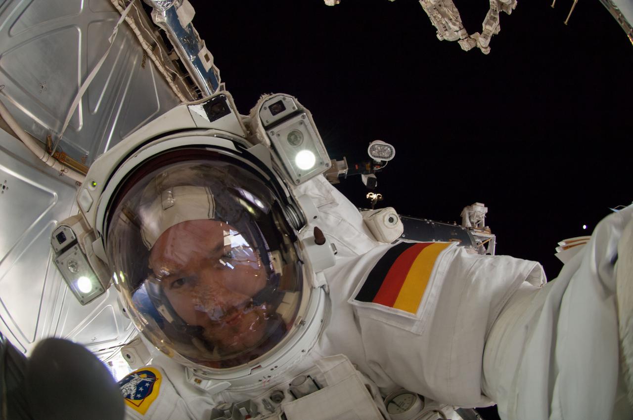 ISS041-E-067002 (7 Oct. 2014) --- NASA astronaut Reid Wiseman, Expedition 41 flight engineer, participates in a session of extravehicular activity (EVA) as work continues on the International Space Station. During the six-hour, 13-minute spacewalk, Wiseman and European Space Agency astronaut Alexander Gerst (out of frame), flight engineer, worked outside the space station's Quest airlock relocating a failed cooling pump to external stowage and installing gear that provides back up power to external robotics equipment.
