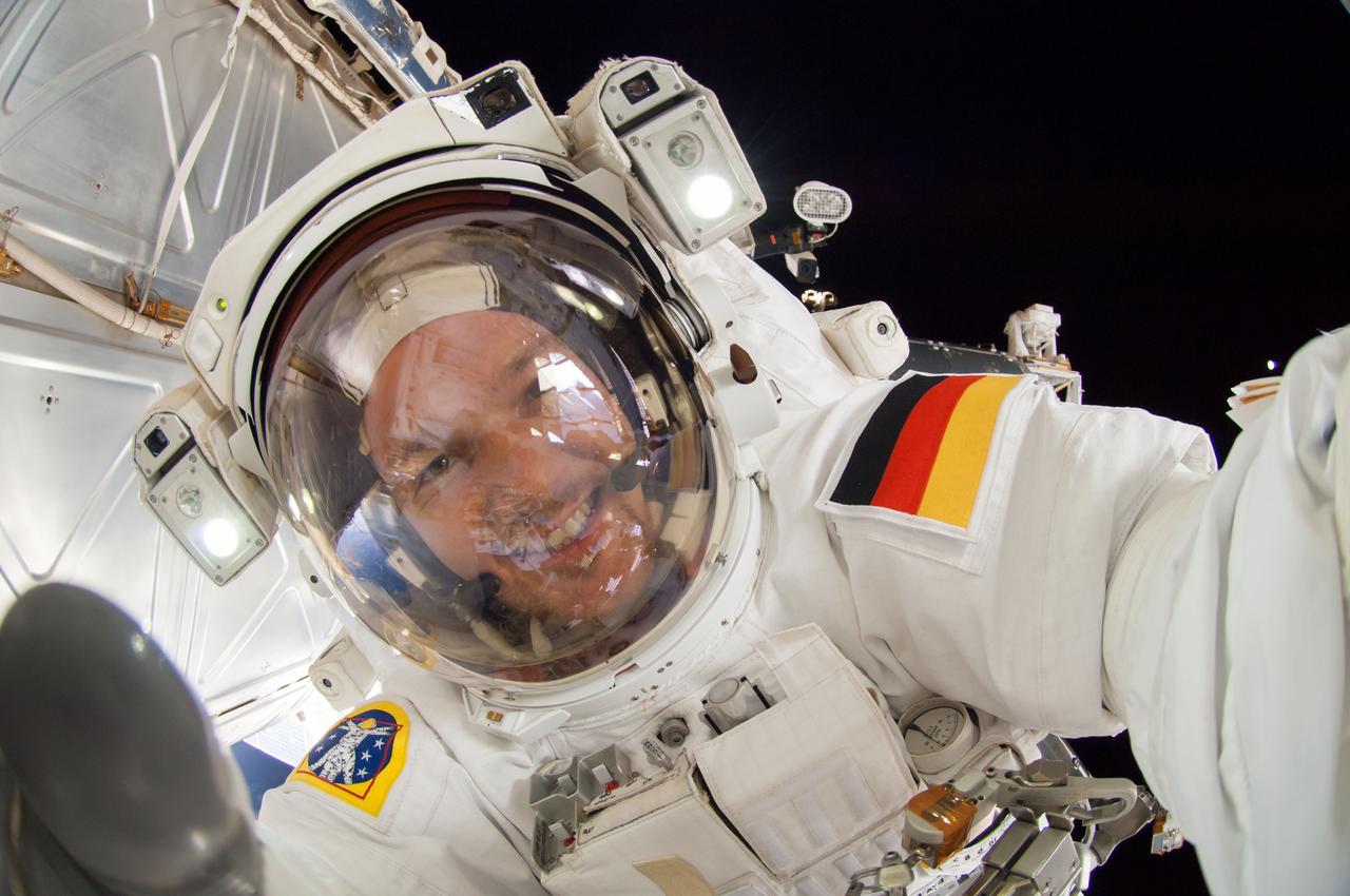 ISS041-E-067002 (7 Oct. 2014) --- NASA astronaut Reid Wiseman, Expedition 41 flight engineer, participates in a session of extravehicular activity (EVA) as work continues on the International Space Station. During the six-hour, 13-minute spacewalk, Wiseman and European Space Agency astronaut Alexander Gerst (out of frame), flight engineer, worked outside the space station's Quest airlock relocating a failed cooling pump to external stowage and installing gear that provides back up power to external robotics equipment.