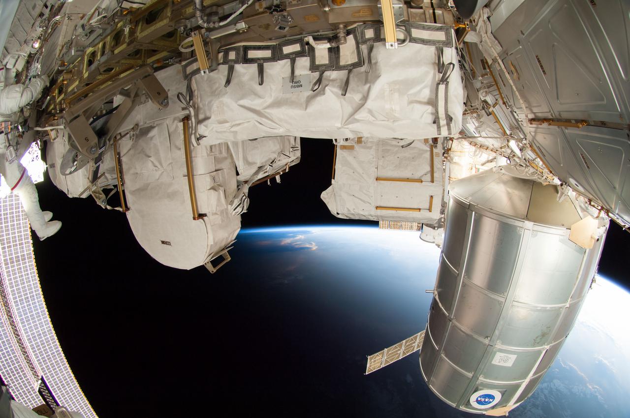 ISS041-E-067002 (7 Oct. 2014) --- NASA astronaut Reid Wiseman, Expedition 41 flight engineer, participates in a session of extravehicular activity (EVA) as work continues on the International Space Station. During the six-hour, 13-minute spacewalk, Wiseman and European Space Agency astronaut Alexander Gerst (out of frame), flight engineer, worked outside the space station's Quest airlock relocating a failed cooling pump to external stowage and installing gear that provides back up power to external robotics equipment.