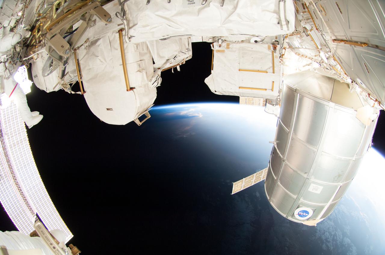 ISS041-E-067002 (7 Oct. 2014) --- NASA astronaut Reid Wiseman, Expedition 41 flight engineer, participates in a session of extravehicular activity (EVA) as work continues on the International Space Station. During the six-hour, 13-minute spacewalk, Wiseman and European Space Agency astronaut Alexander Gerst (out of frame), flight engineer, worked outside the space station's Quest airlock relocating a failed cooling pump to external stowage and installing gear that provides back up power to external robotics equipment.