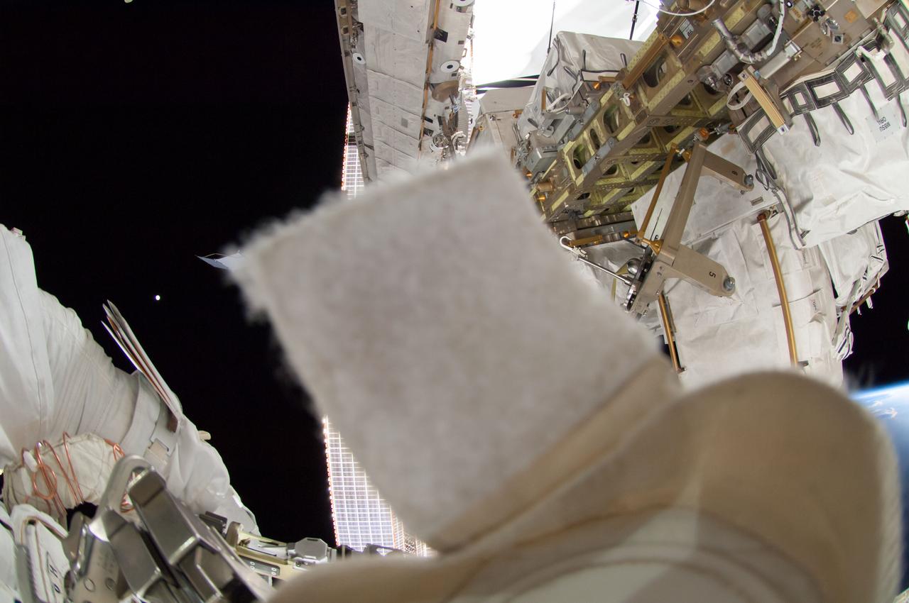 ISS041-E-067002 (7 Oct. 2014) --- NASA astronaut Reid Wiseman, Expedition 41 flight engineer, participates in a session of extravehicular activity (EVA) as work continues on the International Space Station. During the six-hour, 13-minute spacewalk, Wiseman and European Space Agency astronaut Alexander Gerst (out of frame), flight engineer, worked outside the space station's Quest airlock relocating a failed cooling pump to external stowage and installing gear that provides back up power to external robotics equipment.