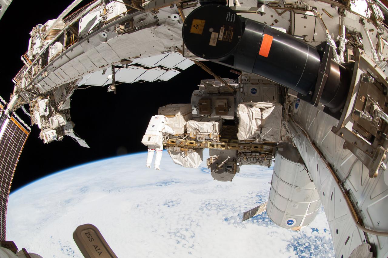 ISS041-E-067002 (7 Oct. 2014) --- NASA astronaut Reid Wiseman, Expedition 41 flight engineer, participates in a session of extravehicular activity (EVA) as work continues on the International Space Station. During the six-hour, 13-minute spacewalk, Wiseman and European Space Agency astronaut Alexander Gerst (out of frame), flight engineer, worked outside the space station's Quest airlock relocating a failed cooling pump to external stowage and installing gear that provides back up power to external robotics equipment.