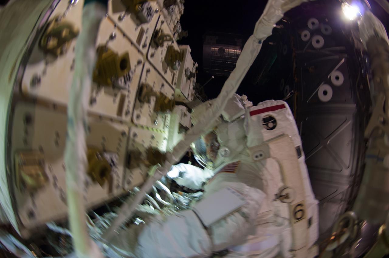 ISS041-E-067002 (7 Oct. 2014) --- NASA astronaut Reid Wiseman, Expedition 41 flight engineer, participates in a session of extravehicular activity (EVA) as work continues on the International Space Station. During the six-hour, 13-minute spacewalk, Wiseman and European Space Agency astronaut Alexander Gerst (out of frame), flight engineer, worked outside the space station's Quest airlock relocating a failed cooling pump to external stowage and installing gear that provides back up power to external robotics equipment.