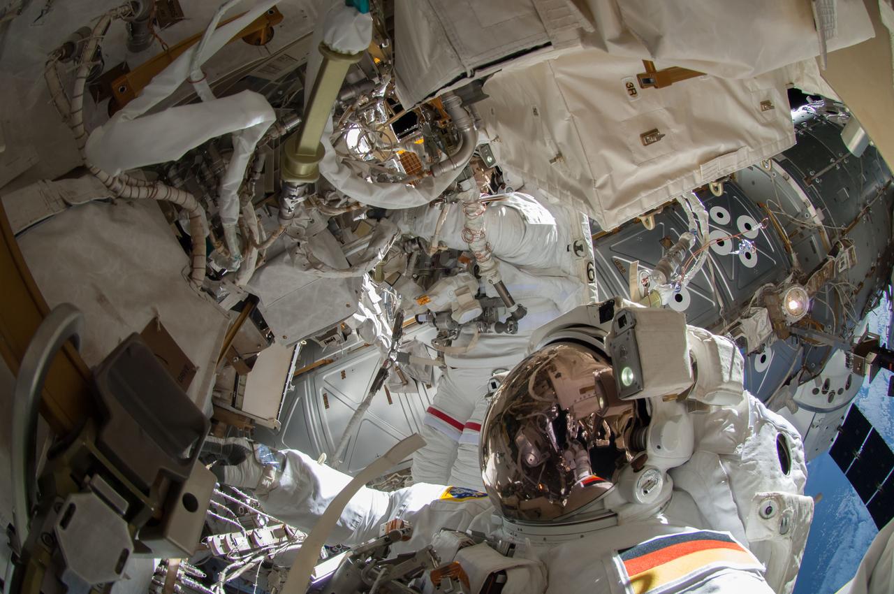 ISS041-E-067002 (7 Oct. 2014) --- NASA astronaut Reid Wiseman, Expedition 41 flight engineer, participates in a session of extravehicular activity (EVA) as work continues on the International Space Station. During the six-hour, 13-minute spacewalk, Wiseman and European Space Agency astronaut Alexander Gerst (out of frame), flight engineer, worked outside the space station's Quest airlock relocating a failed cooling pump to external stowage and installing gear that provides back up power to external robotics equipment.