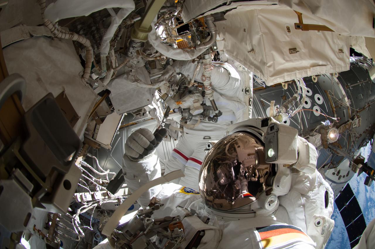 ISS041-E-067002 (7 Oct. 2014) --- NASA astronaut Reid Wiseman, Expedition 41 flight engineer, participates in a session of extravehicular activity (EVA) as work continues on the International Space Station. During the six-hour, 13-minute spacewalk, Wiseman and European Space Agency astronaut Alexander Gerst (out of frame), flight engineer, worked outside the space station's Quest airlock relocating a failed cooling pump to external stowage and installing gear that provides back up power to external robotics equipment.