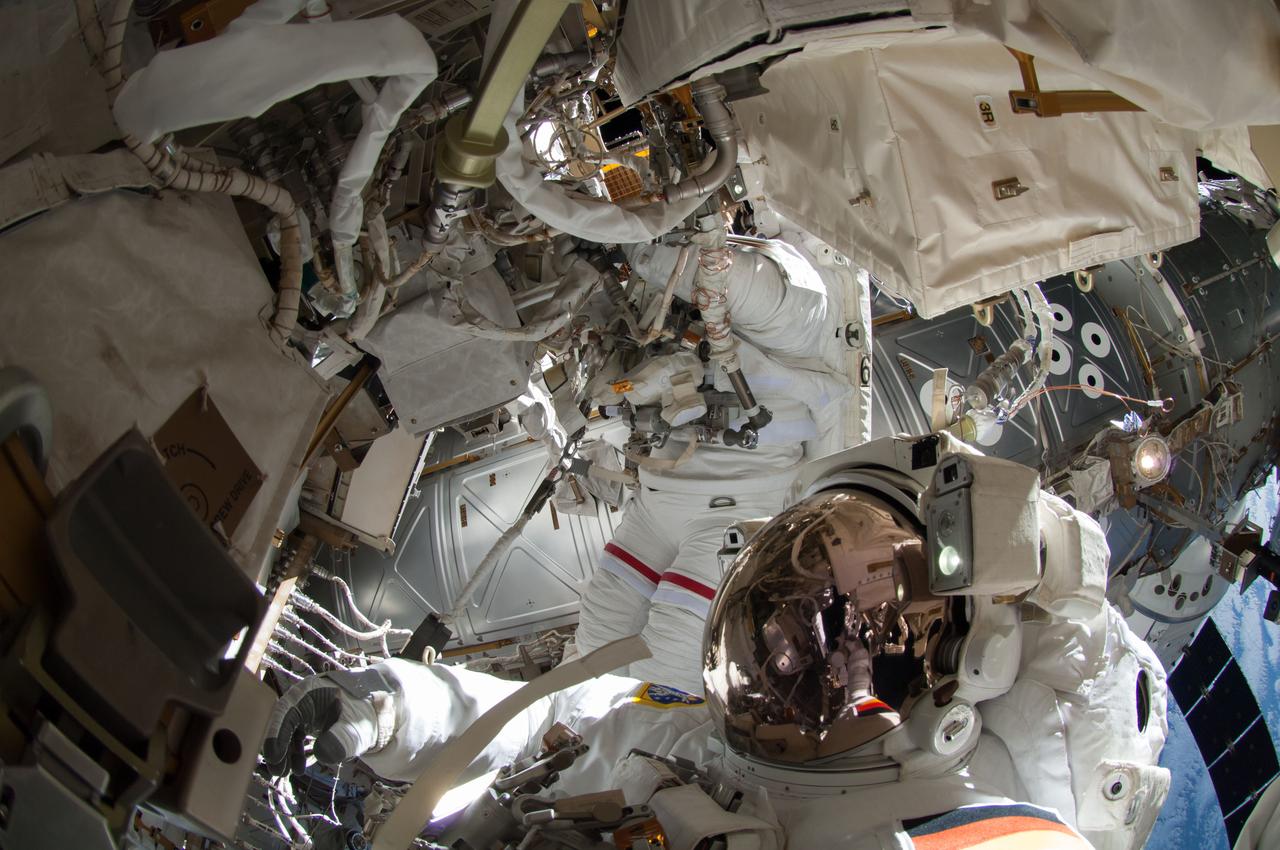 ISS041-E-067002 (7 Oct. 2014) --- NASA astronaut Reid Wiseman, Expedition 41 flight engineer, participates in a session of extravehicular activity (EVA) as work continues on the International Space Station. During the six-hour, 13-minute spacewalk, Wiseman and European Space Agency astronaut Alexander Gerst (out of frame), flight engineer, worked outside the space station's Quest airlock relocating a failed cooling pump to external stowage and installing gear that provides back up power to external robotics equipment.