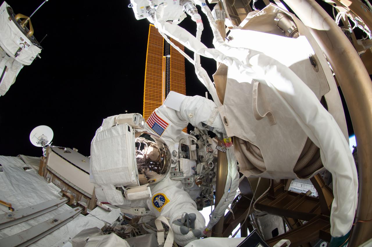 ISS041-E-067002 (7 Oct. 2014) --- NASA astronaut Reid Wiseman, Expedition 41 flight engineer, participates in a session of extravehicular activity (EVA) as work continues on the International Space Station. During the six-hour, 13-minute spacewalk, Wiseman and European Space Agency astronaut Alexander Gerst (out of frame), flight engineer, worked outside the space station's Quest airlock relocating a failed cooling pump to external stowage and installing gear that provides back up power to external robotics equipment.