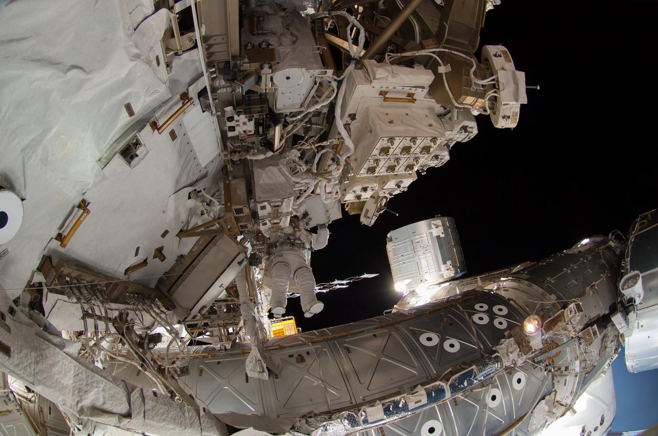 ISS041-E-067002 (7 Oct. 2014) --- NASA astronaut Reid Wiseman, Expedition 41 flight engineer, participates in a session of extravehicular activity (EVA) as work continues on the International Space Station. During the six-hour, 13-minute spacewalk, Wiseman and European Space Agency astronaut Alexander Gerst (out of frame), flight engineer, worked outside the space station's Quest airlock relocating a failed cooling pump to external stowage and installing gear that provides back up power to external robotics equipment.