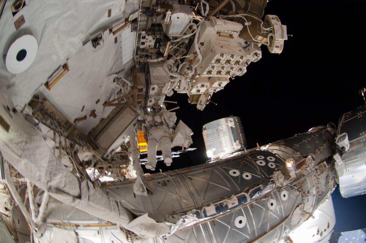 ISS041-E-067002 (7 Oct. 2014) --- NASA astronaut Reid Wiseman, Expedition 41 flight engineer, participates in a session of extravehicular activity (EVA) as work continues on the International Space Station. During the six-hour, 13-minute spacewalk, Wiseman and European Space Agency astronaut Alexander Gerst (out of frame), flight engineer, worked outside the space station's Quest airlock relocating a failed cooling pump to external stowage and installing gear that provides back up power to external robotics equipment.