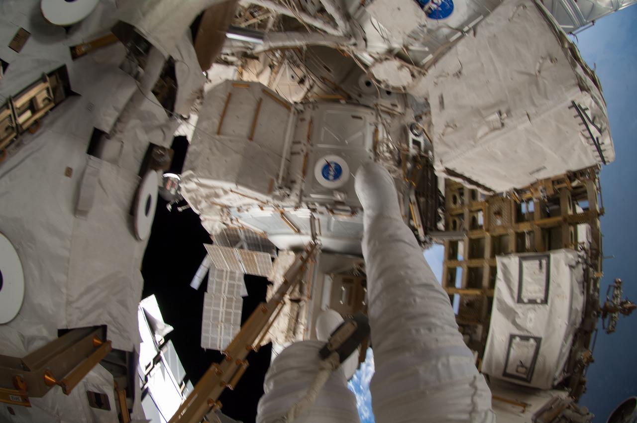 ISS041-E-067002 (7 Oct. 2014) --- NASA astronaut Reid Wiseman, Expedition 41 flight engineer, participates in a session of extravehicular activity (EVA) as work continues on the International Space Station. During the six-hour, 13-minute spacewalk, Wiseman and European Space Agency astronaut Alexander Gerst (out of frame), flight engineer, worked outside the space station's Quest airlock relocating a failed cooling pump to external stowage and installing gear that provides back up power to external robotics equipment.