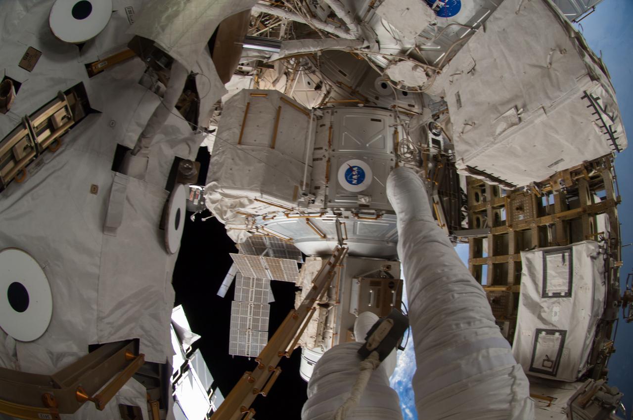 ISS041-E-067002 (7 Oct. 2014) --- NASA astronaut Reid Wiseman, Expedition 41 flight engineer, participates in a session of extravehicular activity (EVA) as work continues on the International Space Station. During the six-hour, 13-minute spacewalk, Wiseman and European Space Agency astronaut Alexander Gerst (out of frame), flight engineer, worked outside the space station's Quest airlock relocating a failed cooling pump to external stowage and installing gear that provides back up power to external robotics equipment.