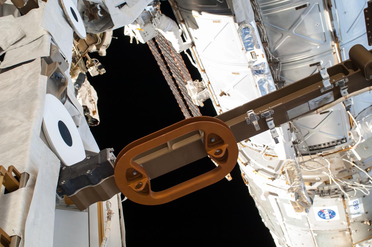 ISS041-E-067002 (7 Oct. 2014) --- NASA astronaut Reid Wiseman, Expedition 41 flight engineer, participates in a session of extravehicular activity (EVA) as work continues on the International Space Station. During the six-hour, 13-minute spacewalk, Wiseman and European Space Agency astronaut Alexander Gerst (out of frame), flight engineer, worked outside the space station's Quest airlock relocating a failed cooling pump to external stowage and installing gear that provides back up power to external robotics equipment.