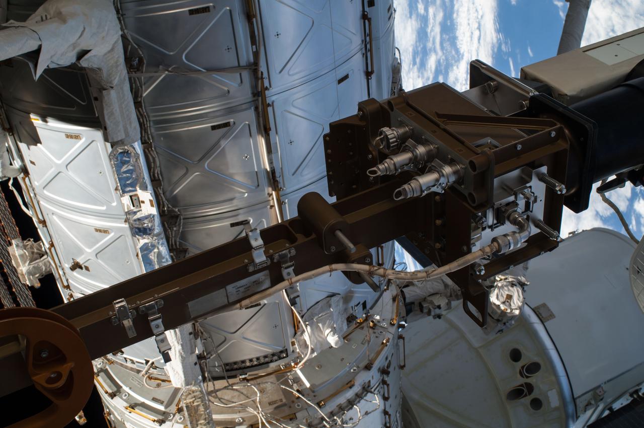 ISS041-E-067002 (7 Oct. 2014) --- NASA astronaut Reid Wiseman, Expedition 41 flight engineer, participates in a session of extravehicular activity (EVA) as work continues on the International Space Station. During the six-hour, 13-minute spacewalk, Wiseman and European Space Agency astronaut Alexander Gerst (out of frame), flight engineer, worked outside the space station's Quest airlock relocating a failed cooling pump to external stowage and installing gear that provides back up power to external robotics equipment.