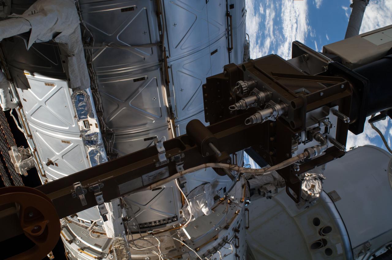 ISS041-E-067002 (7 Oct. 2014) --- NASA astronaut Reid Wiseman, Expedition 41 flight engineer, participates in a session of extravehicular activity (EVA) as work continues on the International Space Station. During the six-hour, 13-minute spacewalk, Wiseman and European Space Agency astronaut Alexander Gerst (out of frame), flight engineer, worked outside the space station's Quest airlock relocating a failed cooling pump to external stowage and installing gear that provides back up power to external robotics equipment.