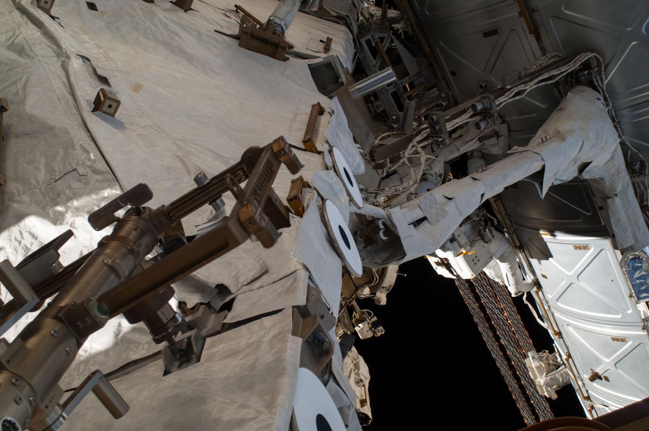 ISS041-E-067002 (7 Oct. 2014) --- NASA astronaut Reid Wiseman, Expedition 41 flight engineer, participates in a session of extravehicular activity (EVA) as work continues on the International Space Station. During the six-hour, 13-minute spacewalk, Wiseman and European Space Agency astronaut Alexander Gerst (out of frame), flight engineer, worked outside the space station's Quest airlock relocating a failed cooling pump to external stowage and installing gear that provides back up power to external robotics equipment.