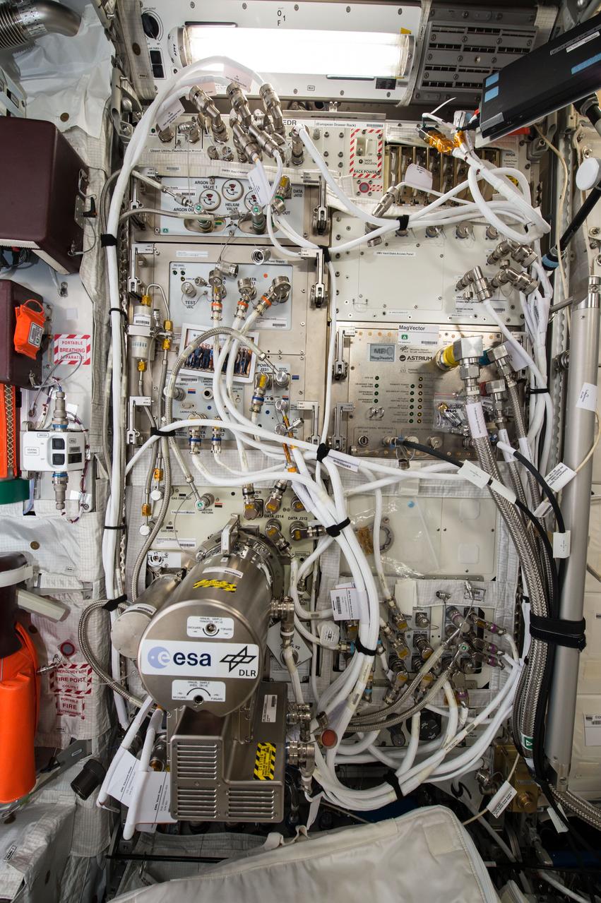 iss041e096097 (10/23/2014) — Photo documentation of the Electromagnetic Levitator (EML) in the Columbus module of the International Space Station (ISS). The EML multi-user facility is designed for containerless materials processing in space.