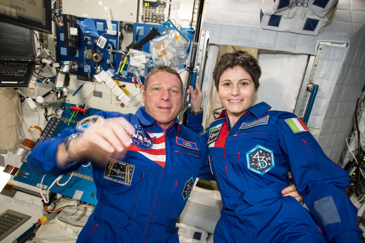 iss042e013622 (11/24/2014) --- US Astronaut Terry Virts and European Space Agency Astronaut Samantha Cristoforetti aboard the International Space Station take a break from working on science experiments to prepare for an interview.