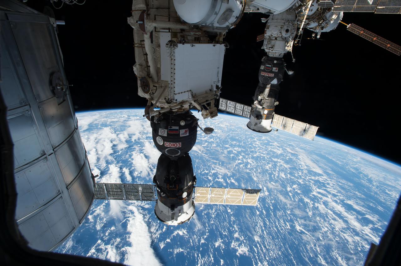 View of the Soyuz TMA-15M spacecraft docked to Rassvet Mini-Research Module 1 (MRM1) and the Progress 57P spacecraft docked to Pirs Docking Compartment (DC1). Portions of the Leonardo Permanent Multipurpose Module (PMM), aft ISS, and an Earth limb are in view. Image was released by astronaut on Twitter.