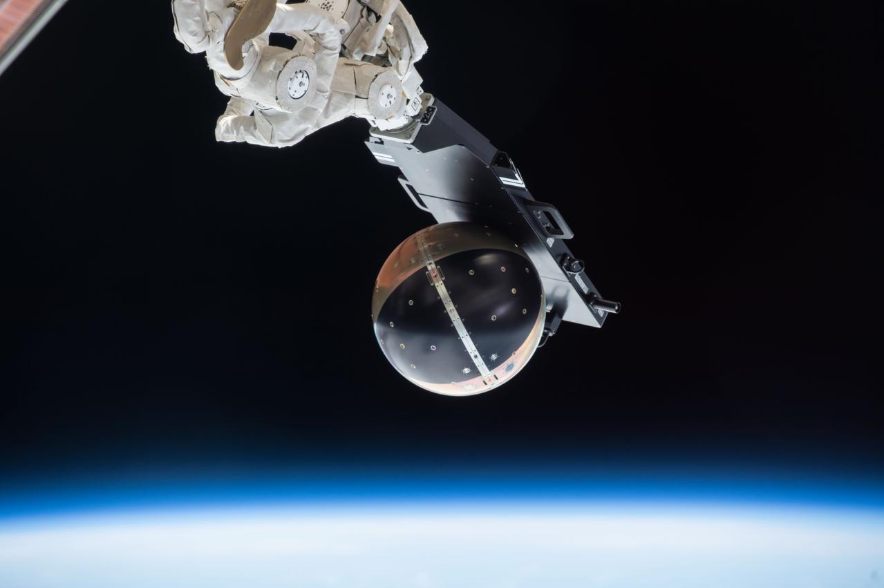 iss042e016906 (11/28/2014) --- The Space Station Integrated Kinetic Launcher for Orbital Payload Systems (SSIKLOPS), or Cyclops, launch platform with Special Purpose Inexpensive Satellite (SpinSat) attached is grappled by the Japanese Experiment Module Remote Manipulator System (JEMRMS) small fine Arm (SFA) in preparation for the release of SpinSat.