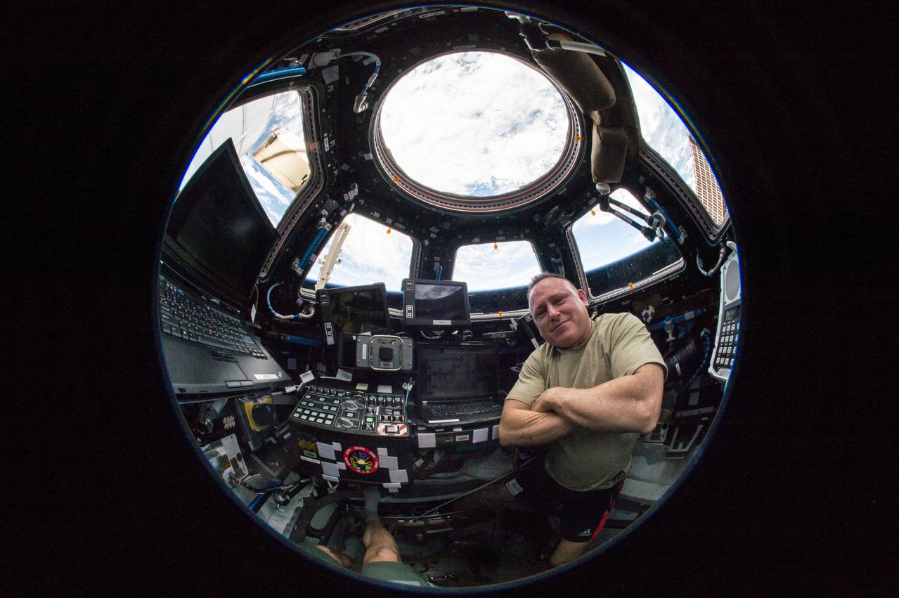 ISS042E119635 (01/11/2015) --- US Astronaut Barry Wilmore, Expedition 42 Commander sits in the International Space Stations CUPOLA after successfully controling the robotic Canadarm to grapple the SPACEX Dragon spacecraft, bringing it into the port where it can be unloaded. It carried 2 and a half tons of supplies and science equipment.