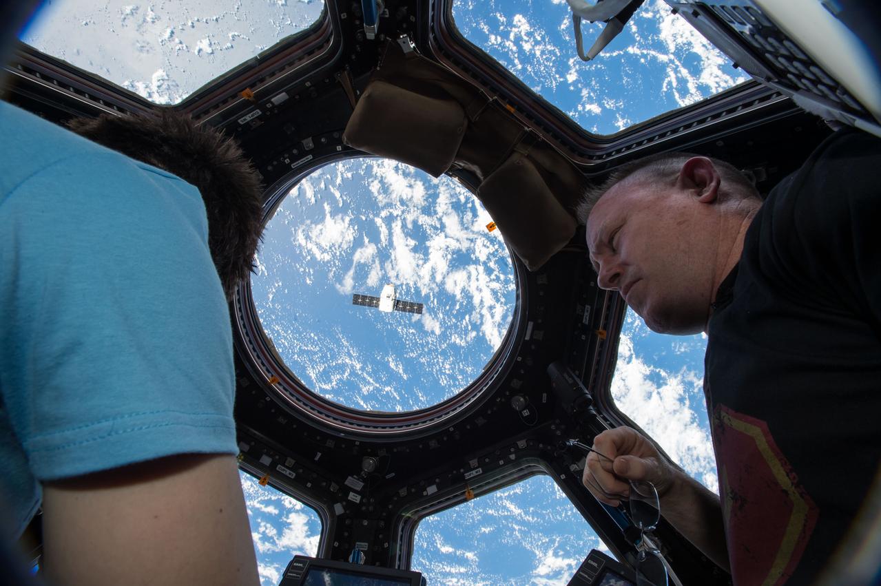 ISS042E119674 (01/12/2015) --- Expedition 42 Commander and NASA Astronaut Barry “Butch” Wilmore, with the assistance of Flight Engineer of the European Space Agency Astronaut Samantha Cristoforetti, prepared to use the Canadarm2 robotic arm to grapple the SpaceX Dragon (CRS-5) ship on Jan. 12 2015. Two days after its launch from the Cape Canaveral Air Force Station, Florida Dragon was attached to the station's Harmony module where it will spend a month being unloaded. Photo Credit: (NASA)