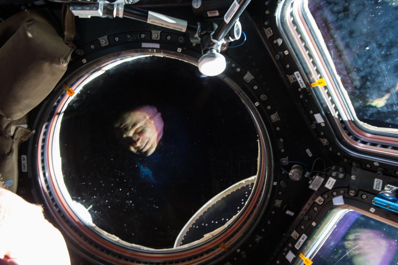 GMT017_17_35_Terry Virts_night shots sunrise dragon reflection in cupola_130B