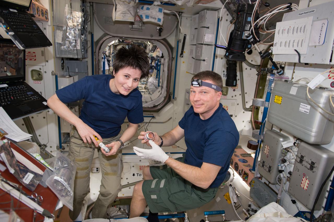 ISS042E207665 (02/03/2015) --- (ESA) European Space Agency astronaut Samantha Cristoforetti, and NASA astronaut Terry Virts are working with configuration tasks aboard the International Space Station on Feb. 3, 2015. Virts tweeted this photo with the comment "@AstroSamantha and I kick off a year of "reconfig", preparing for multiple docked cargo and manned vehicles".