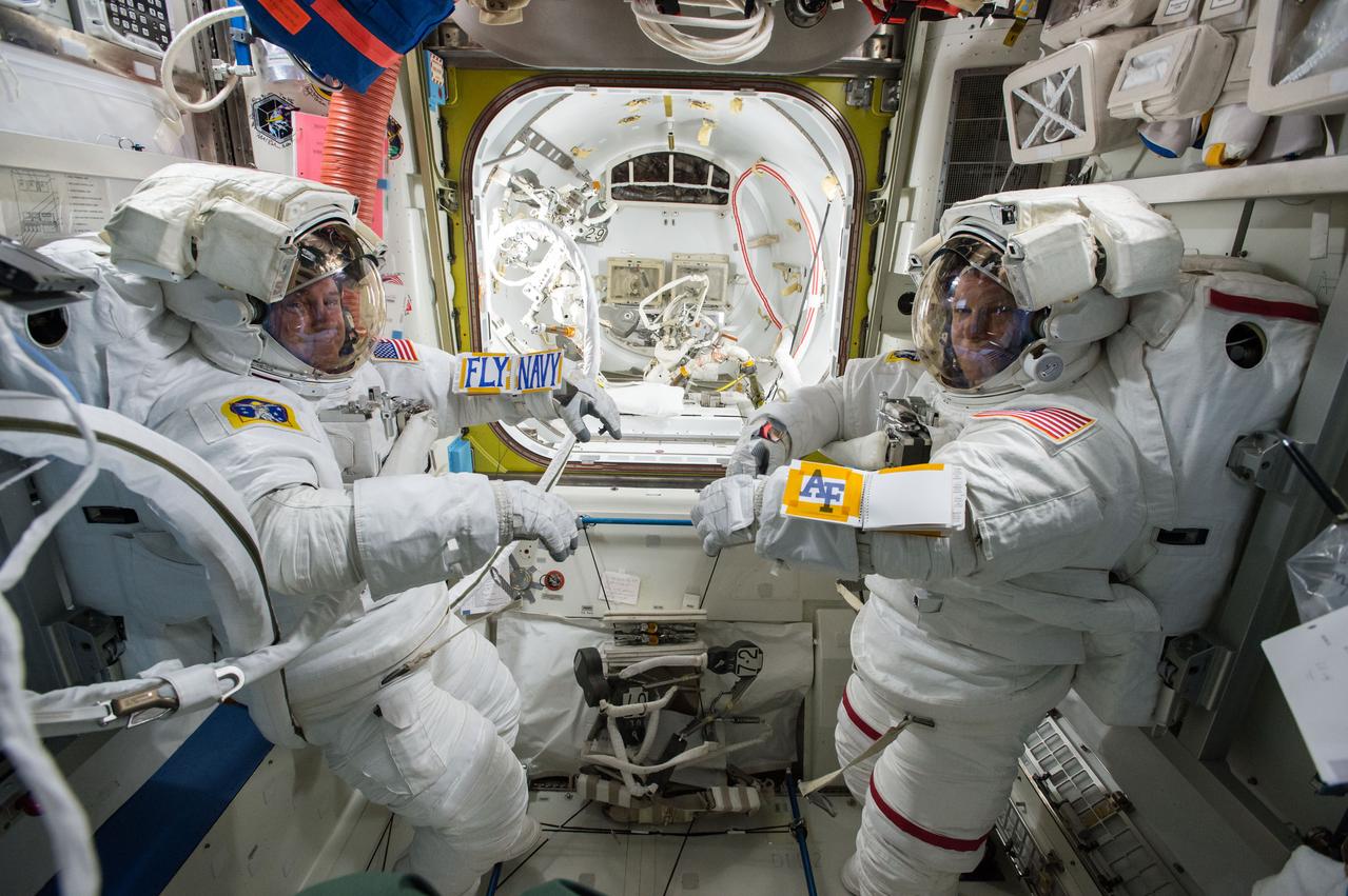 ISS042E292319 (03/01/2015) --- US astronauts Barry "Butch" Wilmore and Terry Virts are suited up Mar 1, 2015 for a later spacewalk outside the International Space Station. Virts tweeted this image with the following comment on Mar. 3, 2015 " Teammates- USAF and USN working great together in orbit and on our spacewalks! #USAFA #goairforcebeatnavy".