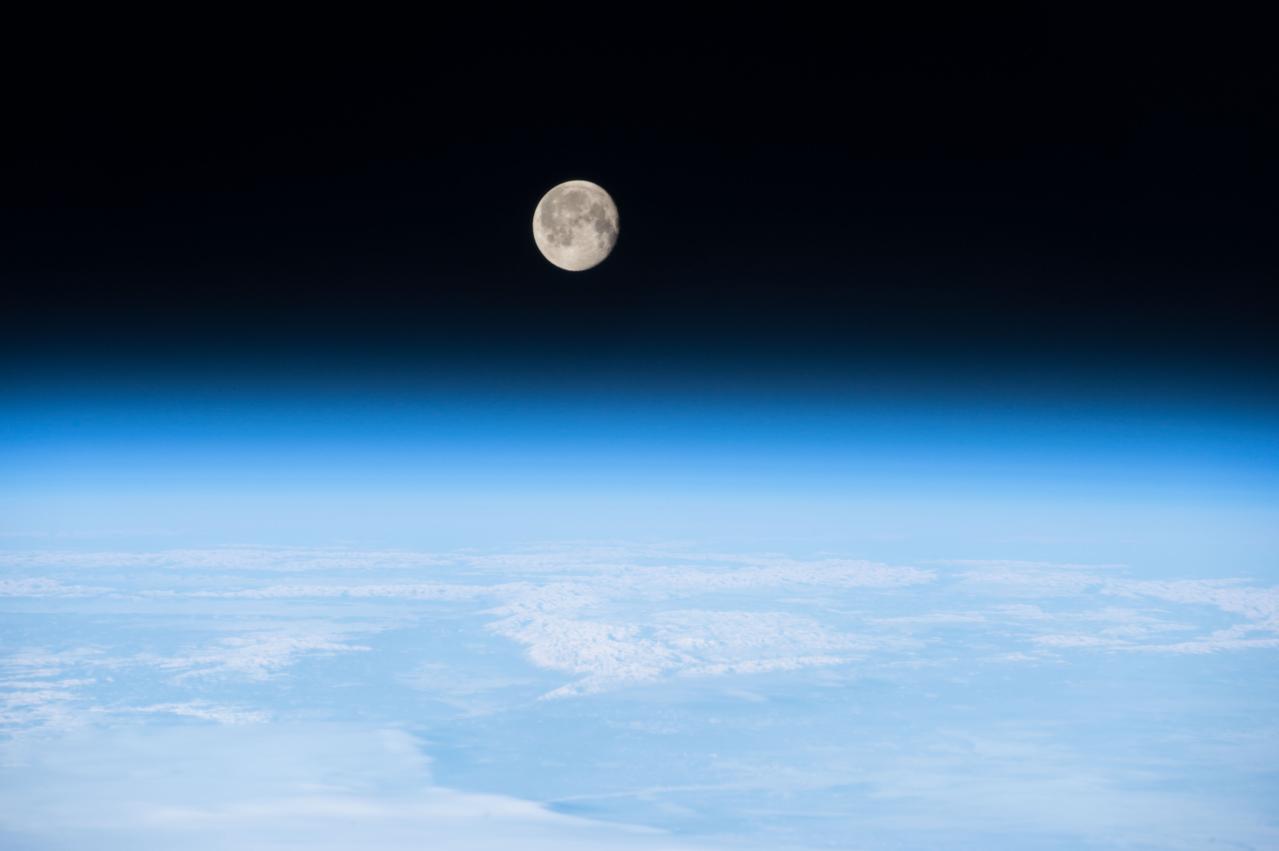 ISS042E307643 (03/08/2015) --- A nearly full moon shines brightly on the Earth’s atmosphere on Mar.8, 2015 enticing astronauts aboard the International Space Station to snap this image as part of the Earth Observation program.