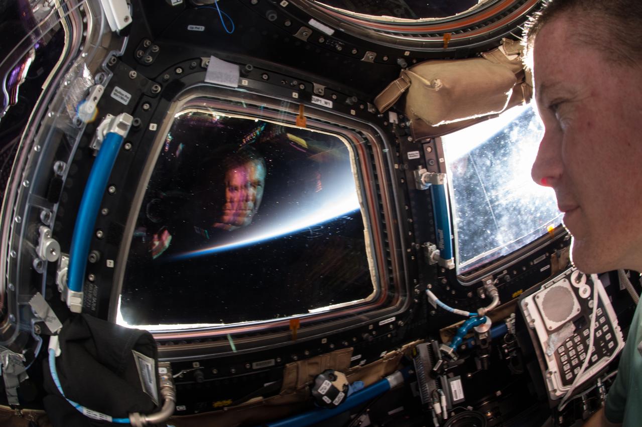 iss043e021247 (03/17/2015) --- NASA astronaut Terry Virts, Commander of Expedition 43 on the International Space Station sees a double image of himself staring back in the stations Cupola window during Earth sunrise on Mar. 17, 2015.