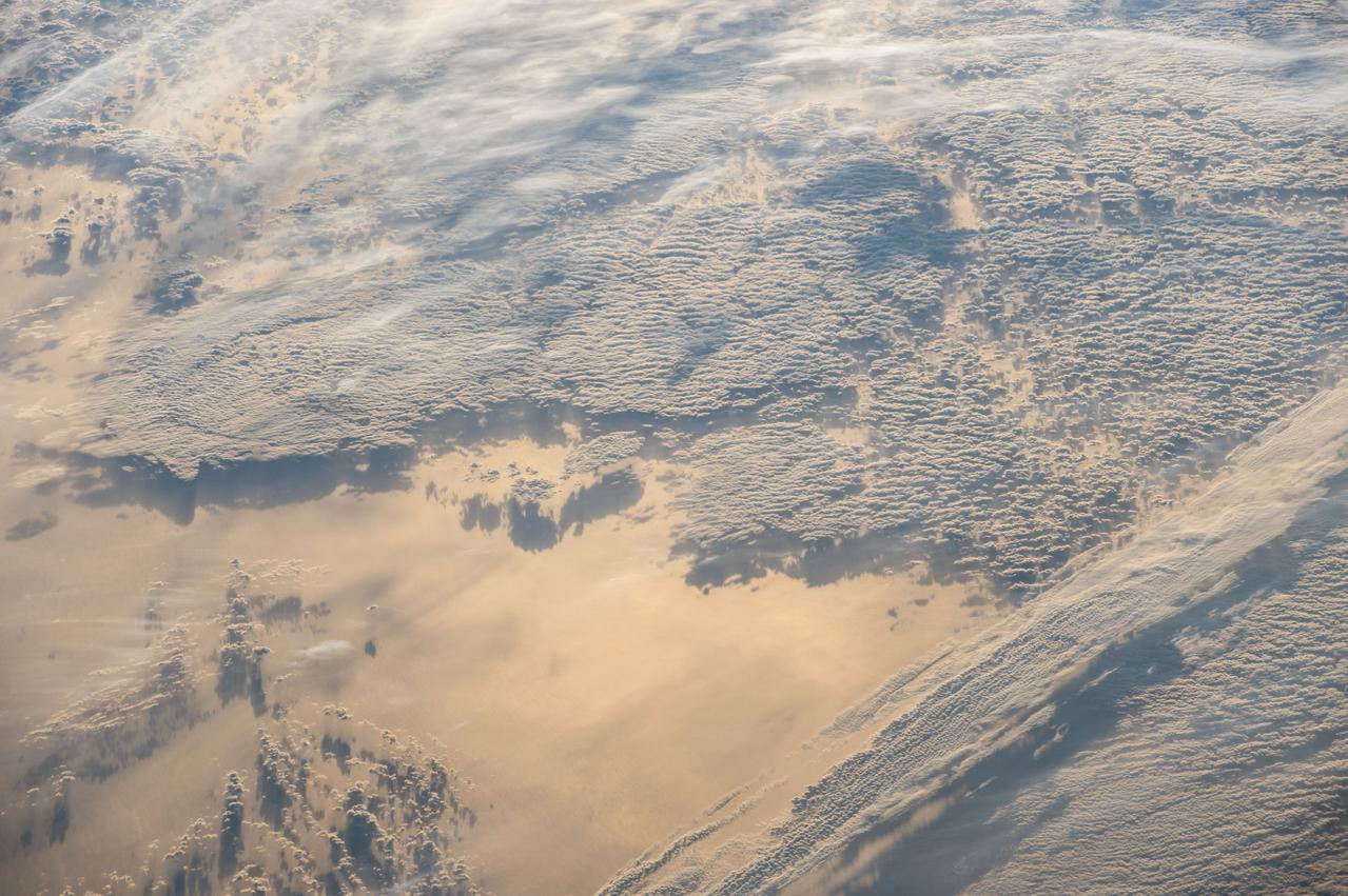 ISS043E045520 (03/23/2015) --- In the northern part of the Earth this observation photo was taken from the International Space Station by members of the Expedition 43 crew on Mar. 23, 2015 showing sun reflected off snow and ice with clouds and shadows making a surreal landscape.