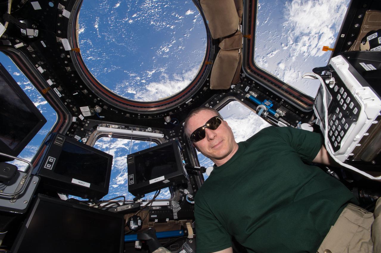 ISS043E091837 (04/07/2015) --- NASA astronaut Terry Virts, Commander of Expedition 43 aboard the International Space Station, dons eye protection from the sun while working in Cupola, the station’s 360 degree viewing platform. The Cupola contains the primary control station for the station’s robotic arm, Canadarm2, which the crew use to capture visiting spacecraft like SpaceX’s Dragon and Orbital ATK’s Cygnus. The specialized windows also provide one of the best vantage points on station for Earth study and photography.