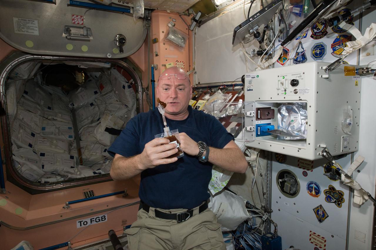 ISS043E160084 (05/03/2015) --- NASA astronaut Scott Kelly enjoys his first drink from the new ISSpresso machine. The espresso device allows crews to make tea, coffee, broth, or other hot beverages they might enjoy.