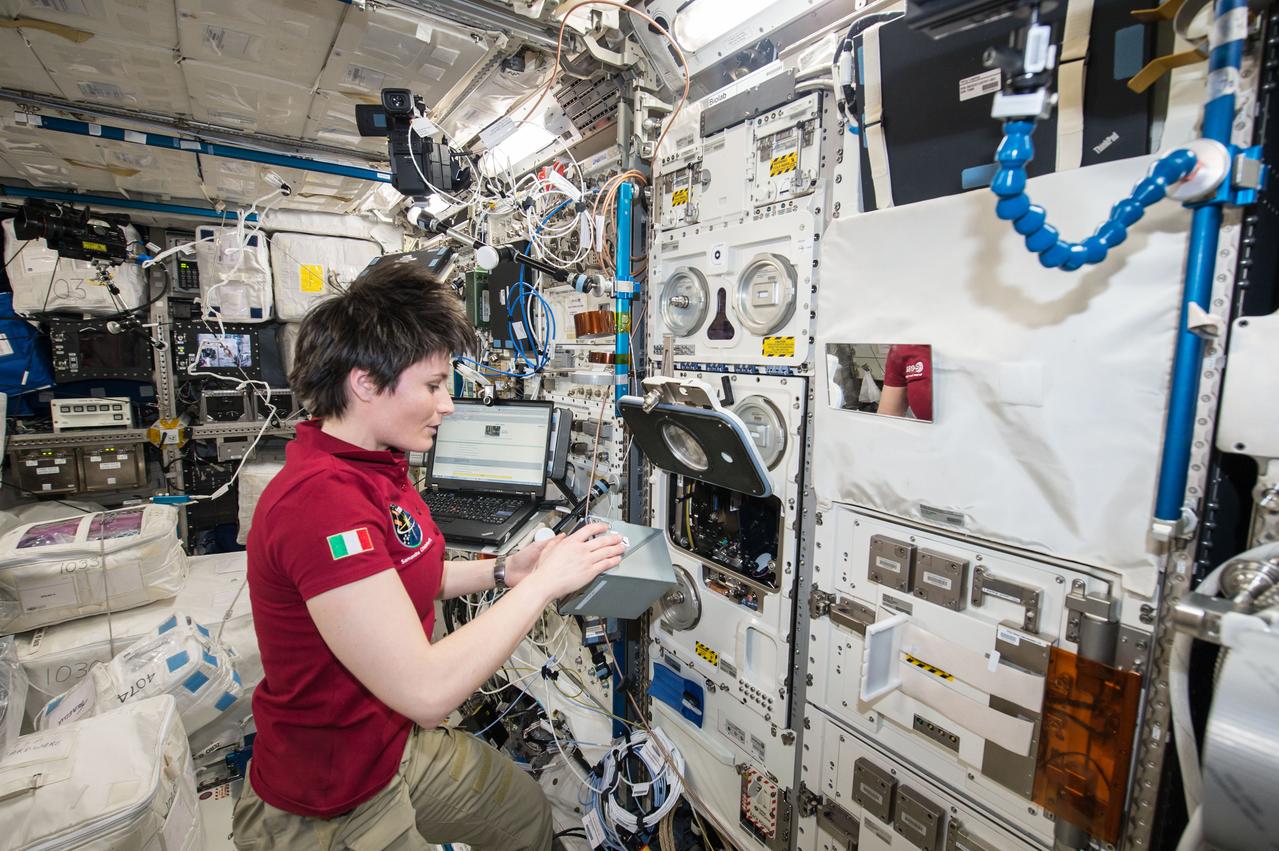 iss043e181041 (May 8, 2015) --- European Space Agency (ESA) astronaut Samantha Christoforetti prepares the TripleLux-A experiment for return on SpaceX's Dragon cargo craft. The TripleLux-A experiment studies the effects of the spaceflight conditions on immune suppresion in mice, which will help scientists understand the effects of radiation and microgravity on the human immune system in space.